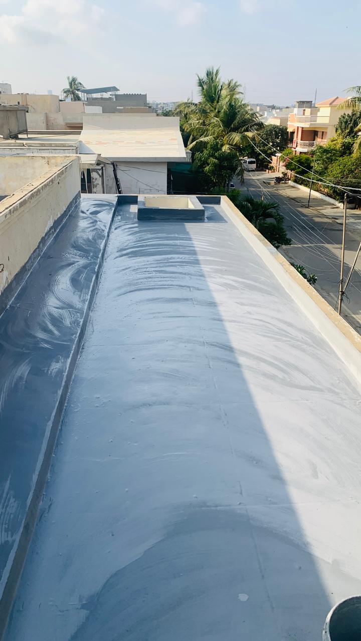 Roofing worker inspecting a finished exterior